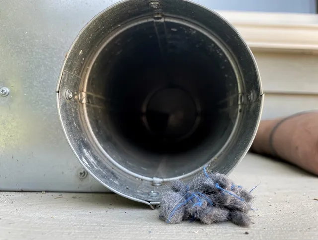 Copley Dryer Vent Cleaning technician using specialized equipment to clear severe dryer vent blockage in Copley